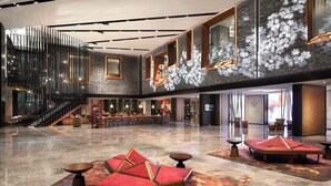 A spacious lobby with a central staircase, seating areas, and a bar. - Renaissance Xi'an Hotel (Xi'an)