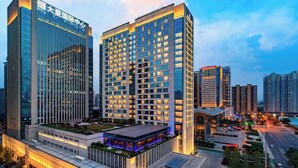 A high-rise hotel with multiple floors, a rooftop terrace, and a well-lit entrance. - Renaissance Xi'an Hotel (Xi'an)