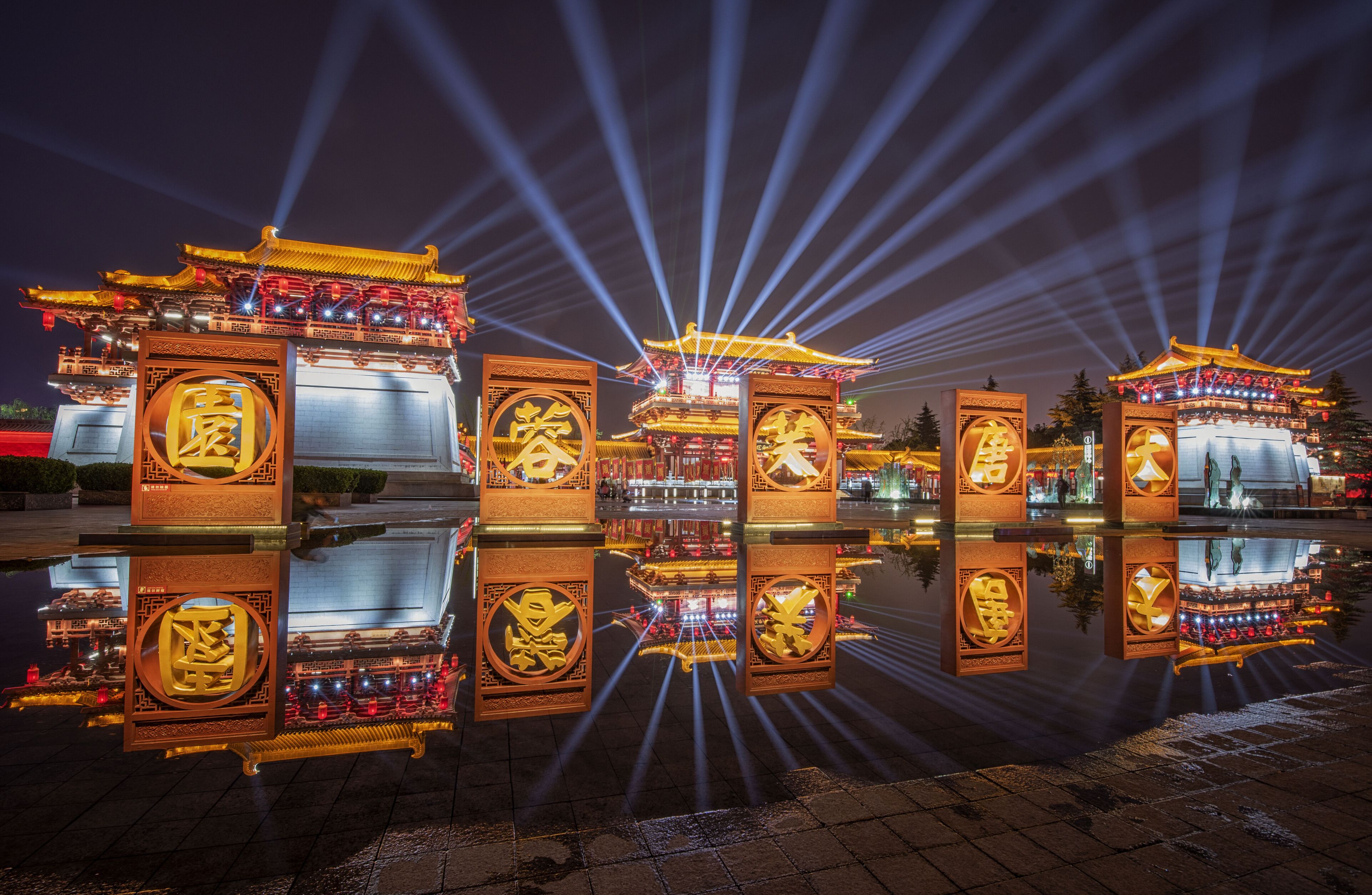 A traditional Chinese pavilion with ornate decorations and a reflection in the water.