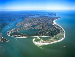 An aerial view of a coastal city with a bay, a large urban area, and a beach. - Beachfront 2BR/2BA Marco Island condo with pool, WiFi, and full kitchen. (Marco Island)
