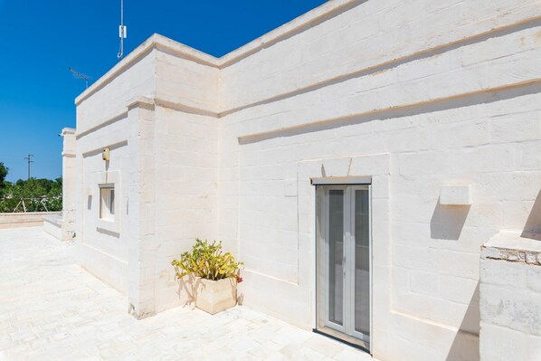 A white building with a door and a window.