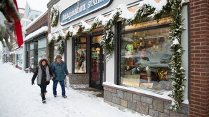 A storefront with a sign reading "Imagination Station" and snow on the ground. - Lake Placid Inn Main Street (Lake Placid)