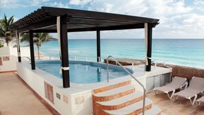 A pool area with a pergola, steps leading to the pool, and lounge chairs. - Club GR Caribe Cancun – Premier All Inclusive (Cancun)