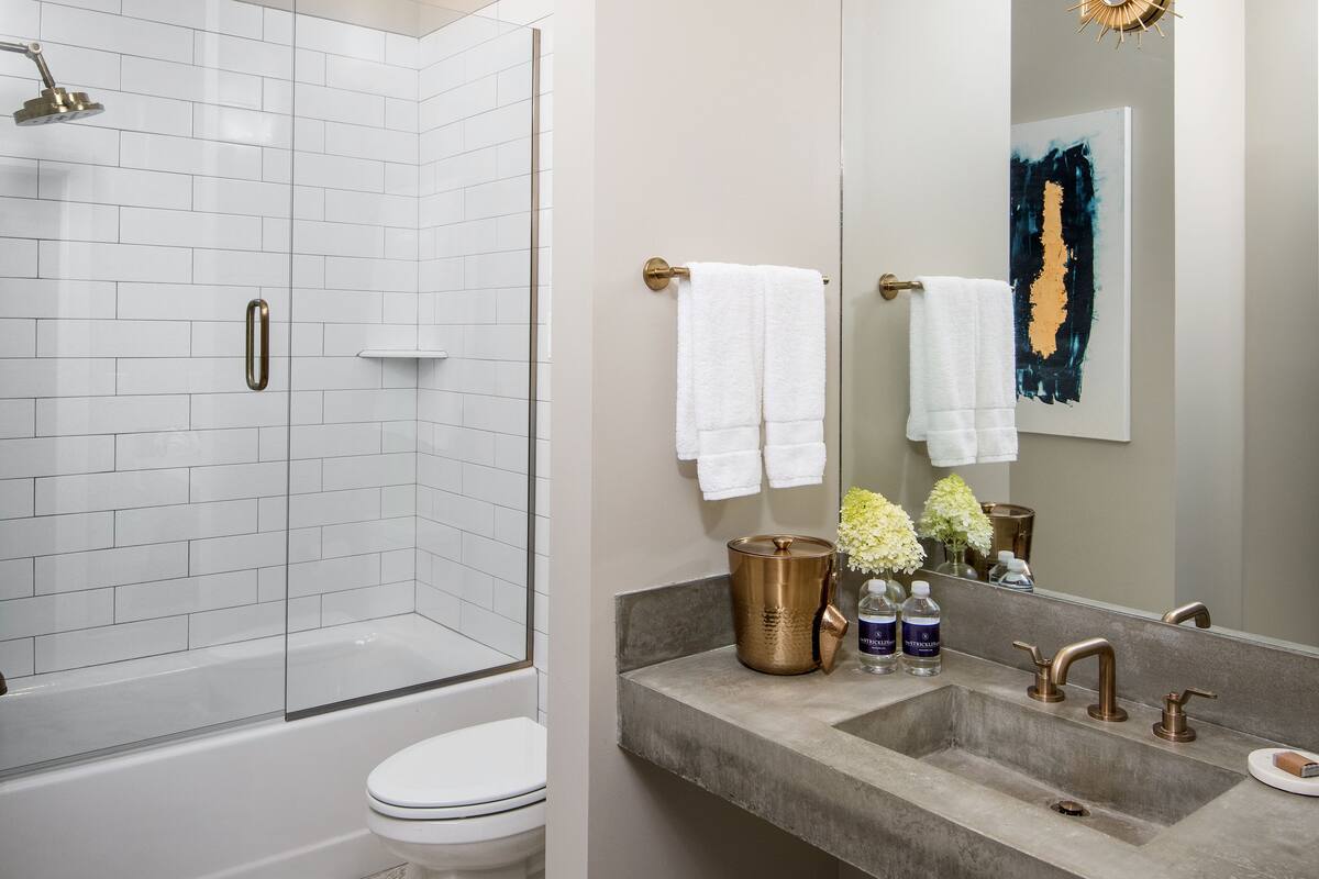 deep-soaking bathtub, rainfall showerhead, designer toiletries