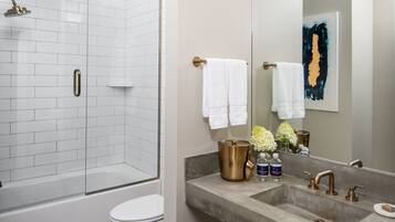 Deep soaking tub, rainfall showerhead, designer toiletries, hair dryer