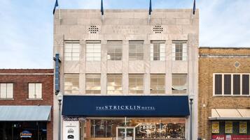 A historic building with a large sign reading "The Stricklin Hotel" and a "BBQ" sign below.