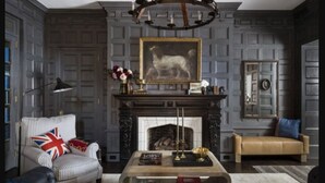 A room with a fireplace, a bookshelf, a leather sofa, and a coffee table. - The George (Montclair)