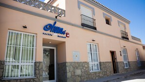 A building with a sign reading "Chana" and a stone base. - Hostel Ohana Tarifa (Tarifa)