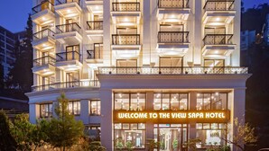 A multi-story hotel with a prominent "VIEW" sign, balconies, and a welcoming entrance. - The View Sapa Hotel (Sa Pa)
