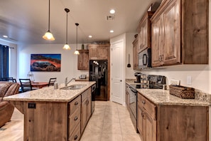 Side View of Kitchen - Side view of kitchen showing off the beautiful counter tops and stainless-steel appliances.