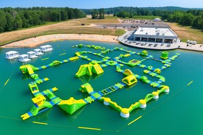 An aerial view of a water park with various play structures and a building with a flat roof.