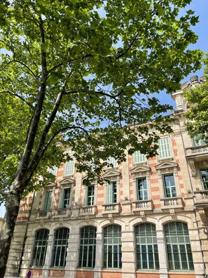 A historic building with classical architecture, featuring multiple windows and a prominent tree in the foreground. - Charming villa in Claviers with private pool and astonishing view  (Claviers)