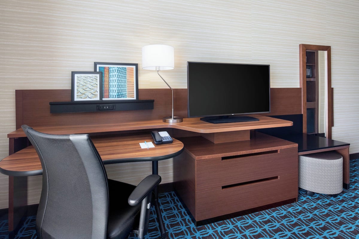 Hypo-allergenic bedding, desk, laptop workspace, blackout drapes