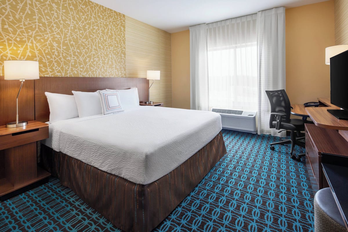 Hypo-allergenic bedding, desk, laptop workspace, blackout drapes