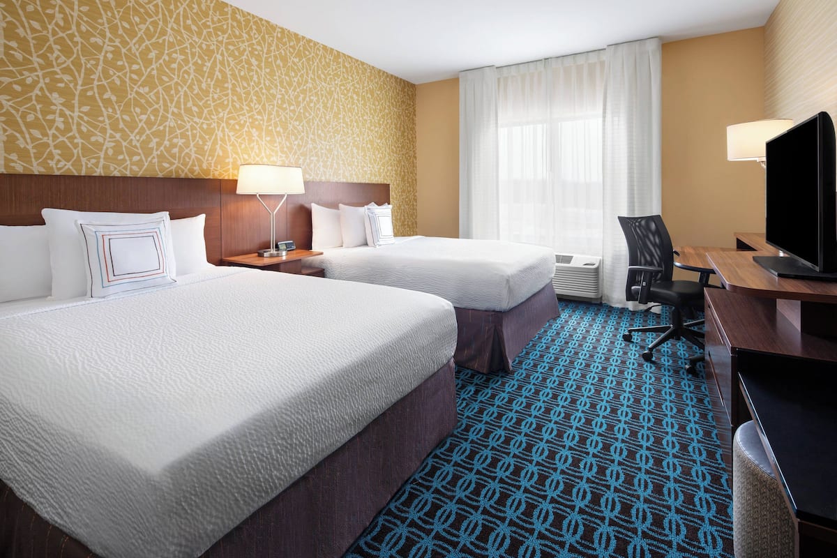 Hypo-allergenic bedding, desk, laptop workspace, blackout drapes