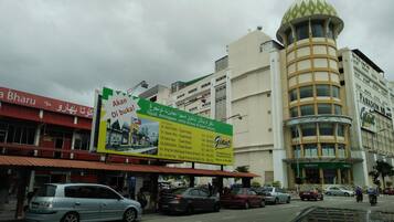 A street view with a large billboard advertising a hotel.