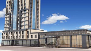 A modern building with a restaurant on the ground floor. - Ramada by Wyndham Beylikduzu (Istanbul)