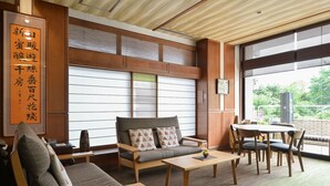 A modern interior with a sofa, chairs, a table, and a large window. - Mimatsukan (Shibukawa)