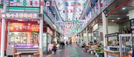 A shopping mall with multiple levels, featuring various shops and a central walkway.