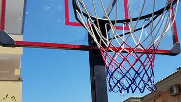 A basketball hoop with a red and blue frame, labeled "Garlando Sports and Games."