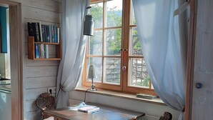 A room with a wooden desk, a chair, a bookshelf, and a window with curtains. - 'Sissi' a charming apartment in a modern country house style (Oberammergau)