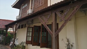 A traditional house with wooden balconies, large windows, and a tiled roof. - Keerawan House Rim Khong (Phon Phisai)