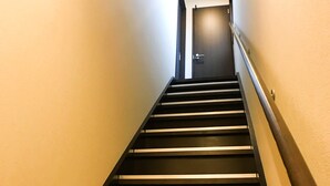A staircase with a handrail leading to a door at the top. - One More Heart at Kamishichiken 2 (Kyoto)