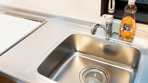 A stainless steel kitchen sink with a faucet, a bottle of dish soap, and a paper towel holder. - GH One More Heart at Toji 2 (Kyoto)