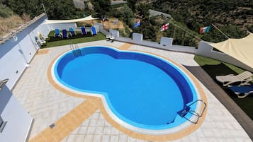 Seasonal outdoor pool, pool umbrellas, pool loungers