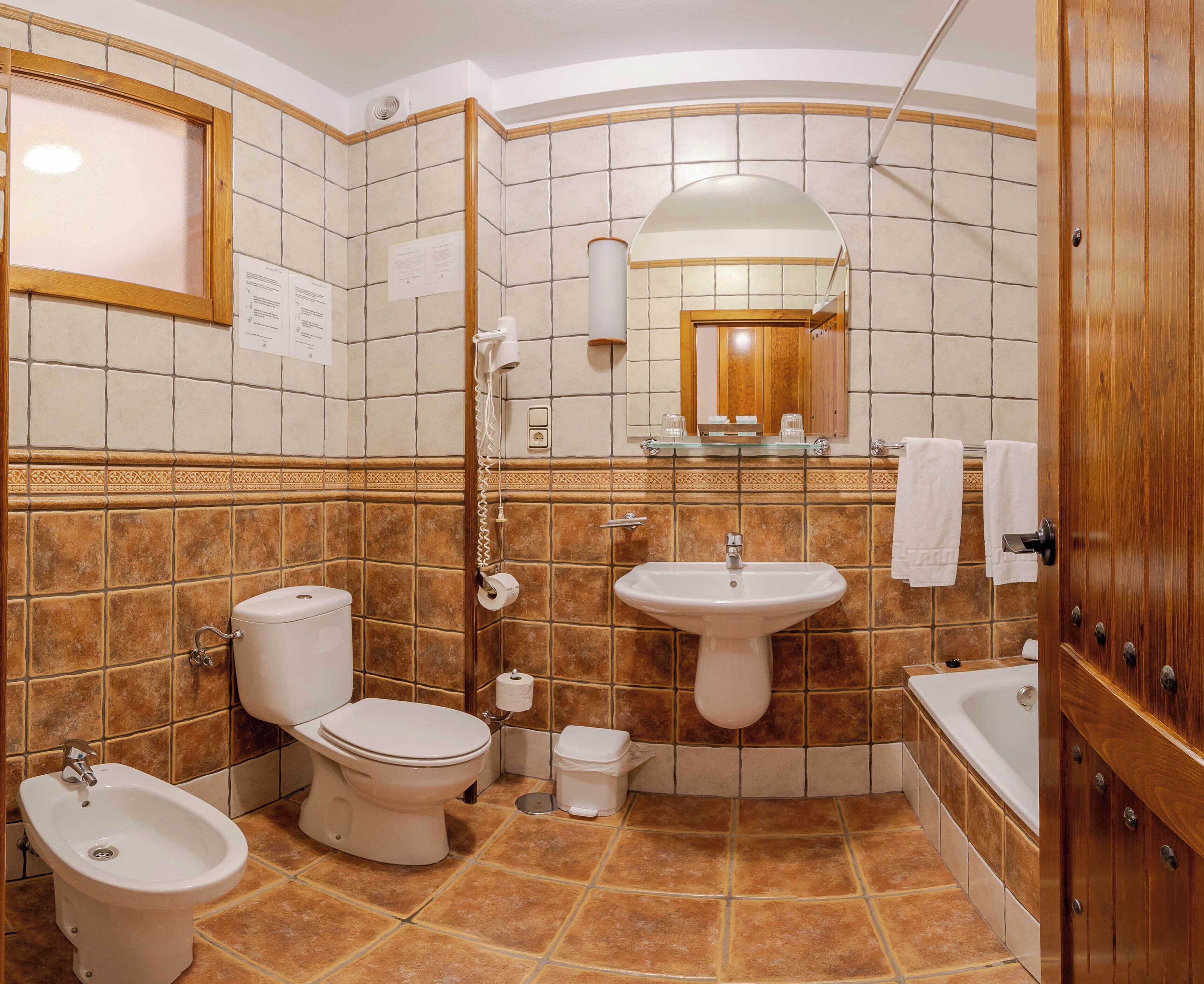 Un bany amb bidet, vàter, rentapeus i banyera.