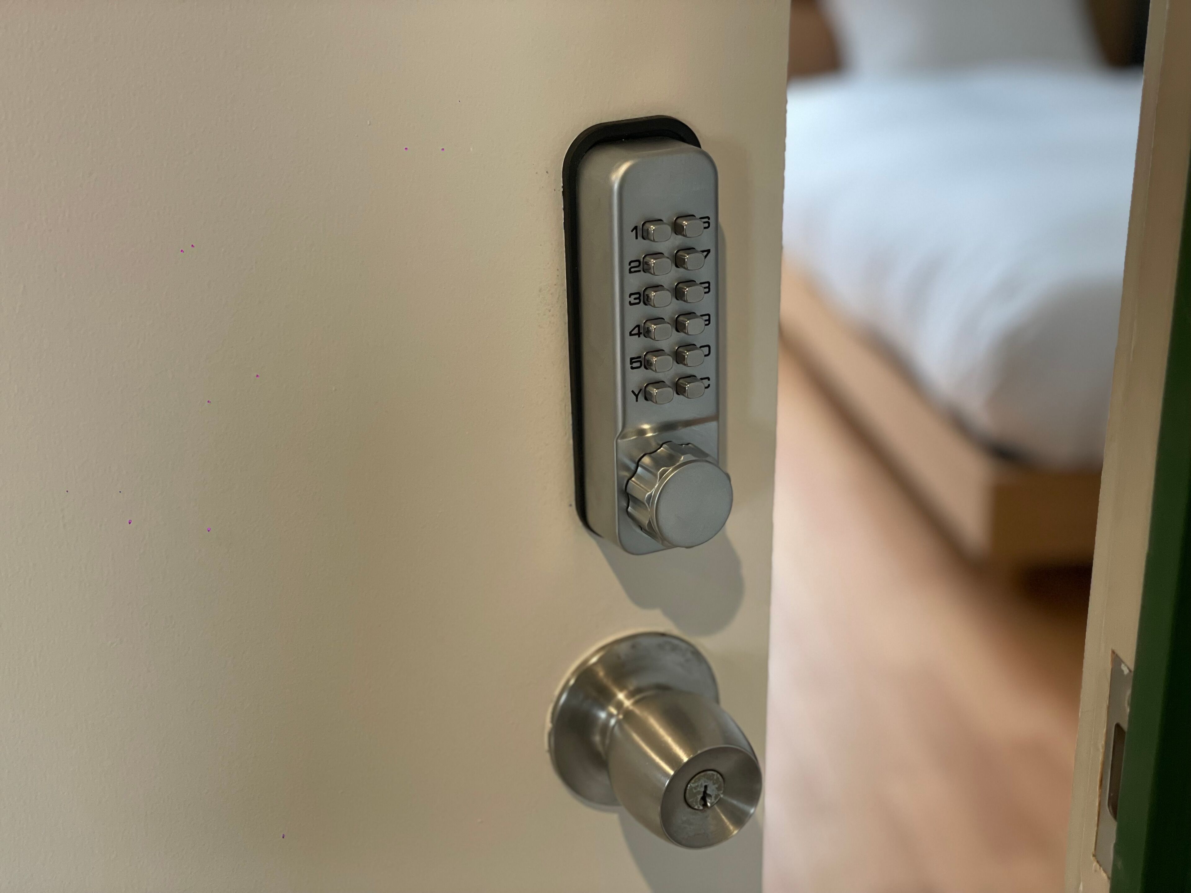 A door with a numeric keypad lock and a keyhole.