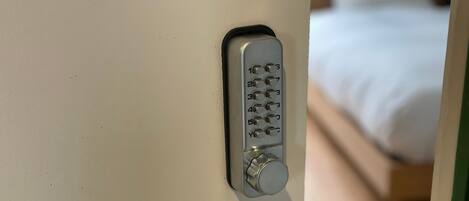A door with a numeric keypad lock and a keyhole.