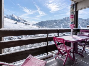 A balcony with a view of a snowy mountain landscape.