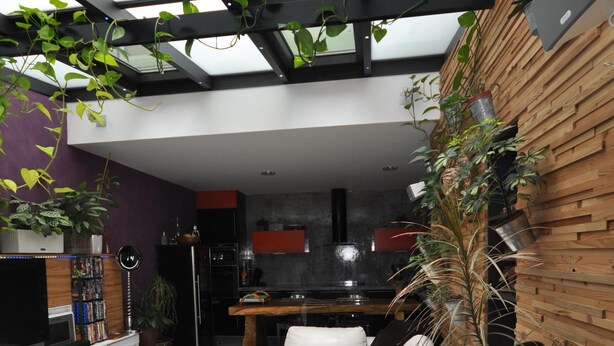 A modern living room with a white sofa, a wooden coffee table, and a large plant. - * THE ATYPICAL LOFT * (Nancy)