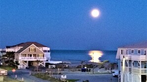 A coastal view with a house and a building with a balcony overlooking the ocean. - GREAT OCEAN VIEWS -- 5 Bedroom, 5.5 Bath, 2 Living Rooms (Ocean Isle Beach)