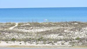 A beach with a sandy path leading to a colorful umbrella. - Blue Wave 🌊 Beach Front View  🌞 Private Pool 🌴 Most Reviews on SGI (Apalachicola)