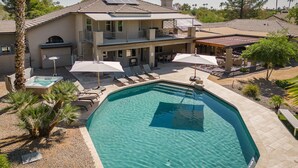 A two-story house with a swimming pool, outdoor seating, and a covered patio area. - SWSS Luxury 7BR Estate | Pickleball | Basketball Pool & Hot Tub | Putting Green | Games (Scottsdale)