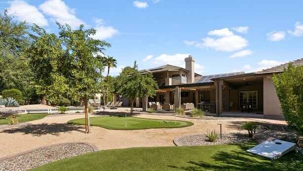 A modern house with a patio, a swimming pool, and a well-maintained lawn. - SWSS Luxury 7BR Estate | Pickleball | Basketball Pool & Hot Tub | Putting Green | Games (Scottsdale)