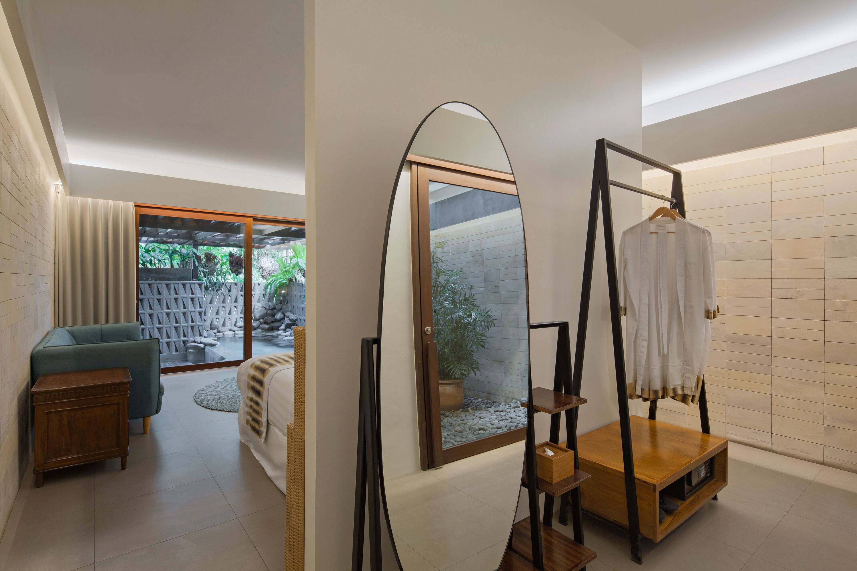 A modern bathroom with a large mirror, a wooden cabinet, and a hanging shower curtain.