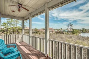 A covered porch with a view of a lake and surrounding trees. - DoctorsOrdersDestin #2 5-Min Walk to Private Beach, Private Heated Pool, Bikes (Destin)