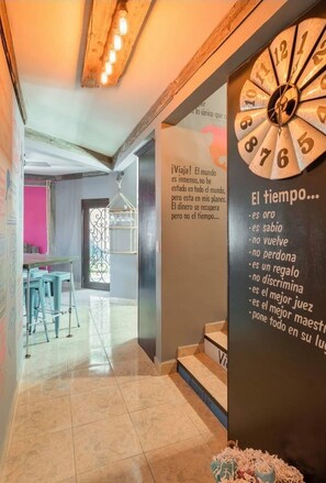 A modern interior with a large clock and motivational quotes on the wall.