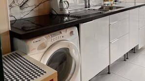 A modern kitchen with a built-in washer and dryer, a microwave, and a coffee maker. - Bright and Spacious STUDIO,  40 sqm, cooling unit, Great View, Wifi, TV,  (Paris)