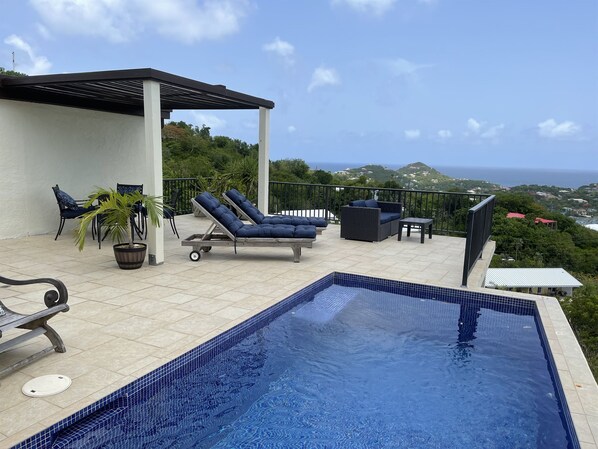 A rooftop pool area with lounge chairs and a view of the ocean. - Private pool 1-bed close to Cruz Bay Ocean views (St john)