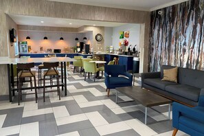 A modern interior with a dining area, kitchen, and seating space.