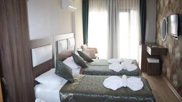 Standard Triple Room | Minibar, in-room safe, desk, soundproofing