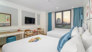 A hotel room with two beds, a desk with a chair, a television, and a large window with curtains. - Grand Sea View Hotel & Spa (Da Nang)