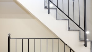 A staircase with black metal railings and marble steps. - Terrazza della Rocca (Cefalù)