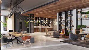 Un salón moderno con una mesa de comedor de madera, asientos cómodos y una amplia estantería llena de libros y objetos decorativos.