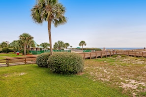 Enjoy a serene beachfront setting with access to the sandy beach via a wooden boardwalk.
