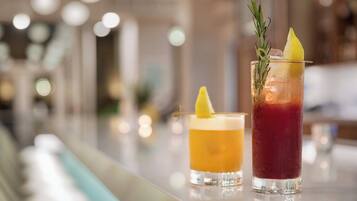 Two drinks on a bar counter with a blurred background.